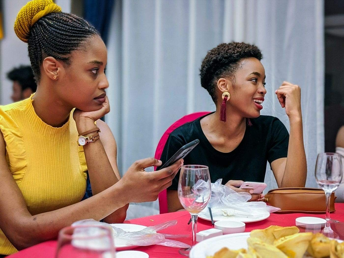 Friends laughing together around a dinner table